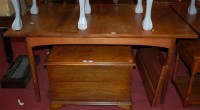 Lot 1275 - A 1970s G-Plan teak dining table, having...