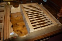 Lot 1301 - A modern pine three tier hanging wall shelf;...