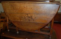 Lot 1305 - An antique joined oak dropleaf dining table,...