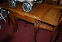 Lot 1308 - A 1930s oak drawleaf dining table