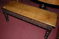 Lot 1325 - An oak low relief carved two seater bench,...