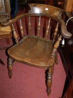 Lot 1359 - An early 20th century elm captains chair