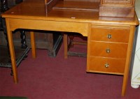 Lot 1384 - A mid-20th century oak writing desk, having...