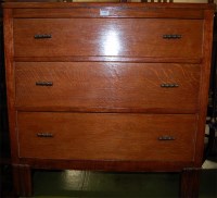 Lot 1417 - A 1930s oak chest of three long drawers
