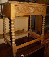 Lot 1219 - A circa 1900 carved oak single drawer side...