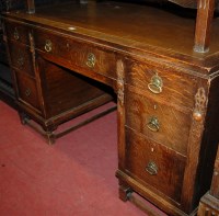 Lot 1424 - An early 20th century moulded oak and rexine...