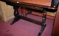 Lot 1431 - An elm trestle end dining table; together with...