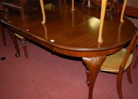 Lot 1334 - An early 20th century walnut extending dining...