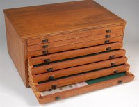 Lot 231 - An eight drawer wooden coin collectors cabinet...