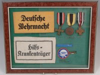 Lot 426 - A framed and glazed display group to include,...