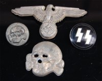 Lot 380 - A German Waffen SS spread eagle cap badge,...