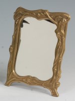 Lot 9 - An Art Nouveau style cast brass easel bedside...