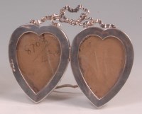 Lot 139 - An Art Nouveau silver double heart shaped...