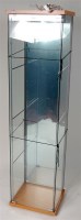 Lot 3161 - A glass retailers display cabinet measuring 64"...