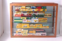 Lot 1970 - Dinky Toys, glass display case, oak framed...