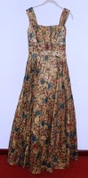 Lot 736 - A 1950s 'gold' dress, printed with roses in...