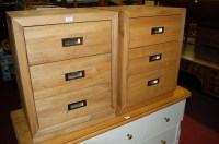 Lot 1192 - A pair of contemporary light oak three drawer...