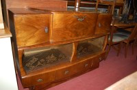 Lot 1196 - A 1950s figured walnut drinks cabinet, having...