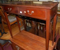 Lot 1198 - A contemporary mahogany two-drawer hall table...