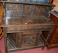 Lot 1210 - An antique and low relief carved oak buffet...