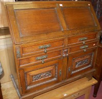 Lot 1213 - An early 20th century carved and moulded oak...