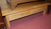 Lot 1214 - A contemporary light oak low two drawer coffee...