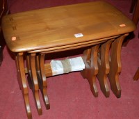 Lot 1222 - An Ercol mid-elm nest of three occasional...