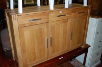 Lot 1237 - A contemporary light oak sideboard, having...