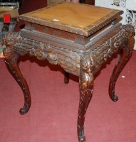 Lot 1257 - A Chinese carved softwood square section urn...