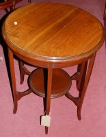 Lot 1274 - An Edwardian walnut circular two tier...