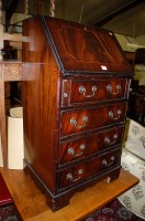 Lot 1277 - A modern flame mahogany narrow slopefront four...