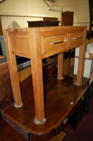 Lot 1310 - A contemporary light oak two drawer hall table,...