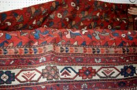 Lot 1356 - A Turkish red ground woollen rug having a...
