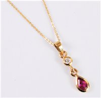 Lot 2581 - An 18ct ruby and diamond pendant, the pear...