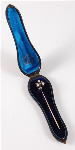Lot 2501 - A diamond stick pin: the three round old cut...
