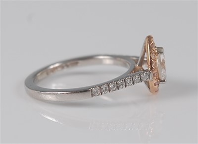 Lot 1173 - A platinum and 18ct rose gold pear shaped...