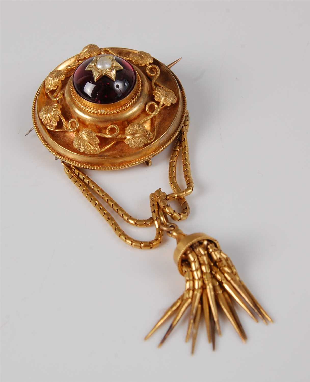 Lot 1177 - A late Victorian yellow metal garnet set...