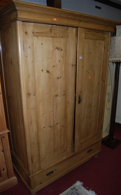 Lot 1166 - A reclaimed pine double door wardrobe, having...
