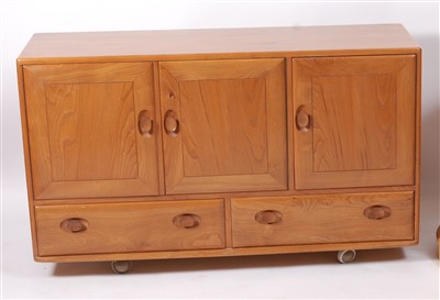 Lot 511 - A 1960s Ercol blond elm sideboard, having...