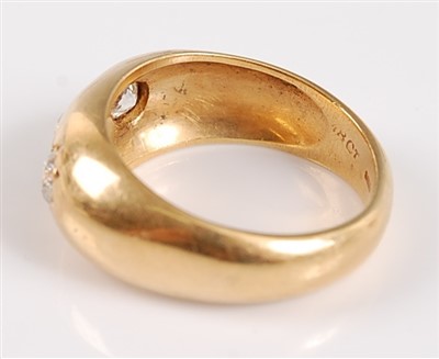 Lot 1192 - An 18ct yellow gold Gypsy style three stone...