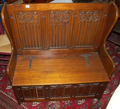 Lot 1312 - An oak three-panelled box seat settle, the...