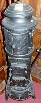 Lot 1140 - A cast iron and black enamelled cathedral type...