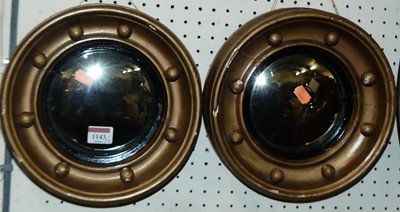 Lot 1143 - A pair of gilt composition convex wall mirrors...