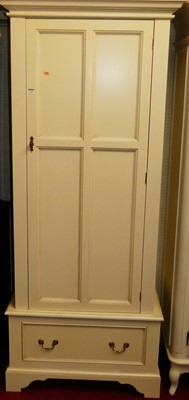 Lot 1146 - A contemporary white wood single door wardrobe,...