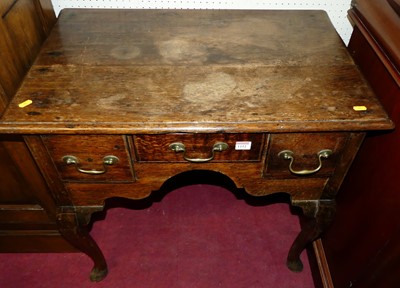 Lot 1152 - A joined oak lowboy, in the Georgian style,...