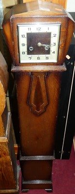Lot 1227 - An Art Deco oak cased grand-daughter clock,...