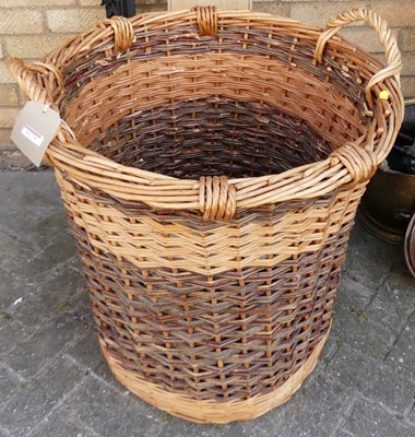 Lot 1175 - A large wicker twin handled cylindrical log...