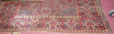 Lot 1199 - A large Persian woollen red ground Bokhara rug,...