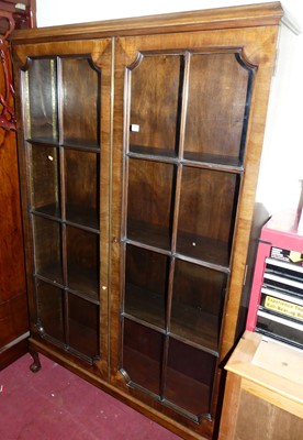 Lot 1218 - An early 20th century walnut double door...