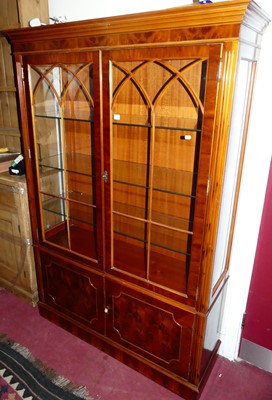 Lot 1209 - A reproduction yew wood double door glazed...